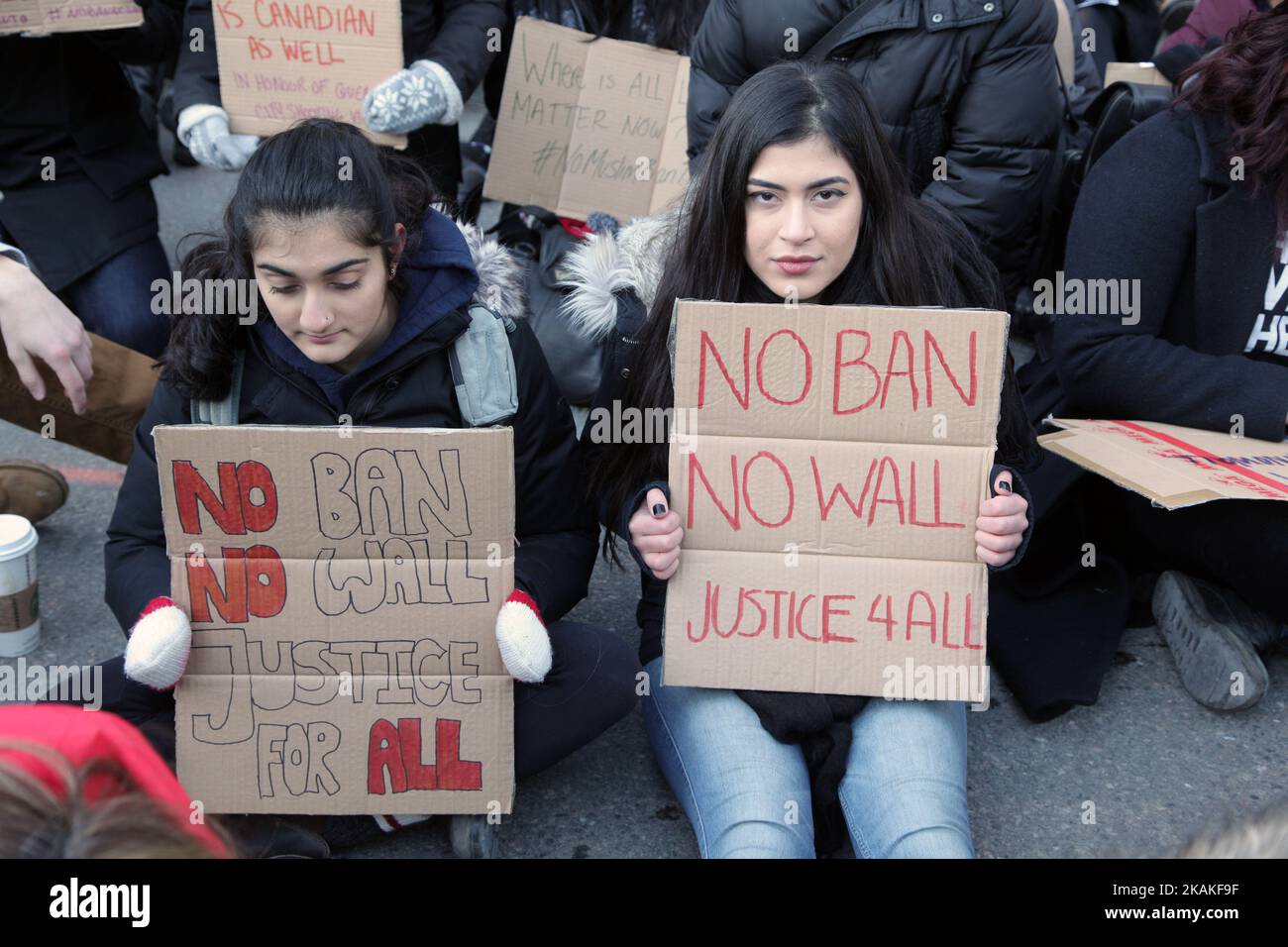 Protestors hold signs saying 'no ban, no wall' during a massive protest against President Trump's travel ban outside of the U.S. Consulate in downtown Toronto, Ontario, Canada, on January 30, 2017. Canadians joined countries around the world in protesting against American President Donald Trump's executive order, banning citizens of seven majority Muslim countries (Iran, Iraq, Sudan, Somalia, Syria, Yemen and Libya) from entering the United States for the next three months and banning Syrian refugees from indefinitely entering America. (Photo by Creative Touch Imaging Ltd./NurPhoto) *** Please Stock Photo