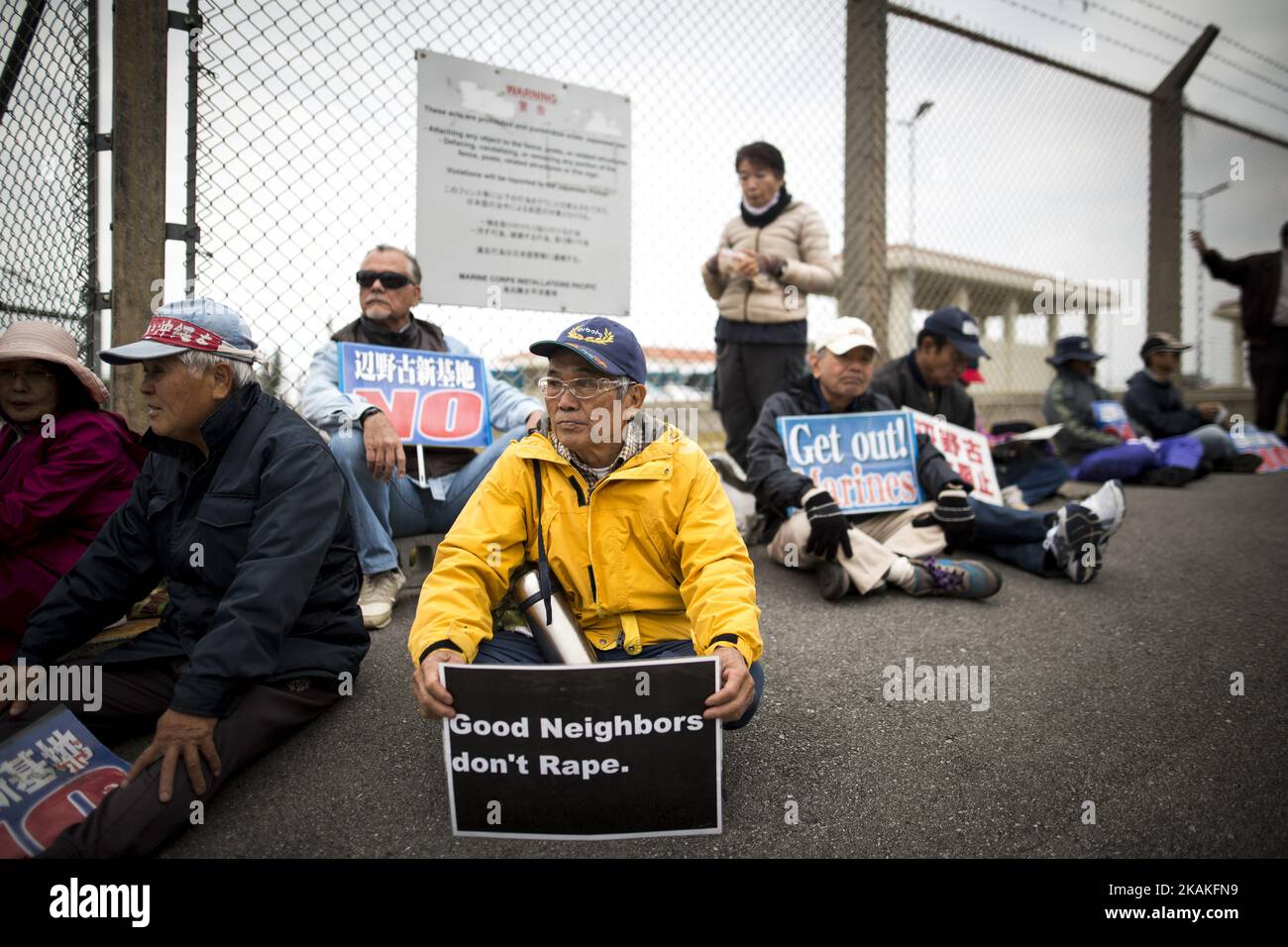 Anti U.S. Base protesters with placards sit outside of the U.S Marine Camp Schwab gate to protest against the construction of the new U.S Marine Airbase in Nago, Okinawa, Japan on Wednesday, February 1, 2017. Okinawa Gov. Takeshi Onaga arrived in the United States on Tuesday, aiming to convey to President Donald TrumpÂ’s administration local opposition to a plan to relocate a U.S. airbase within the southern island prefecture. (Photo by Richard Atrero de Guzman/NurPhoto) *** Please Use Credit from Credit Field *** Stock Photo