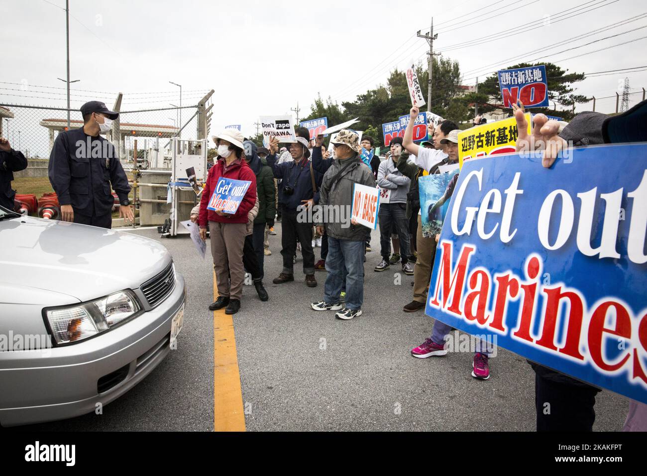Anti U.S. Base protesters shout with placards and block the cars of US marines from getting out of the U.S Marine Camp Schwab gate, protesting against the construction of the new U.S Marine Airbase in Nago, Okinawa, Japan on Wednesday, February 1, 2017. Okinawa Gov. Takeshi Onaga arrived in the United States on Tuesday, aiming to convey to President Donald TrumpÂ’s administration local opposition to a plan to relocate a U.S. airbase within the southern island prefecture. (Photo by Richard Atrero de Guzman/NurPhoto) *** Please Use Credit from Credit Field *** Stock Photo