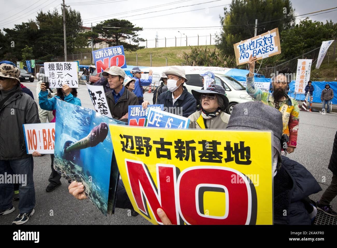 Anti U.S. Base protesters with placards block the cars of US marines in front of the U.S Marine Camp Schwab gate to protest against the construction of the new U.S Marine Airbase in Nago, Okinawa, Japan on Wednesday, February 1, 2017. Okinawa Gov. Takeshi Onaga arrived in the United States on Tuesday, aiming to convey to President Donald TrumpÂ’s administration local opposition to a plan to relocate a U.S. airbase within the southern island prefecture. (Photo by Richard Atrero de Guzman/NurPhoto) *** Please Use Credit from Credit Field *** Stock Photo