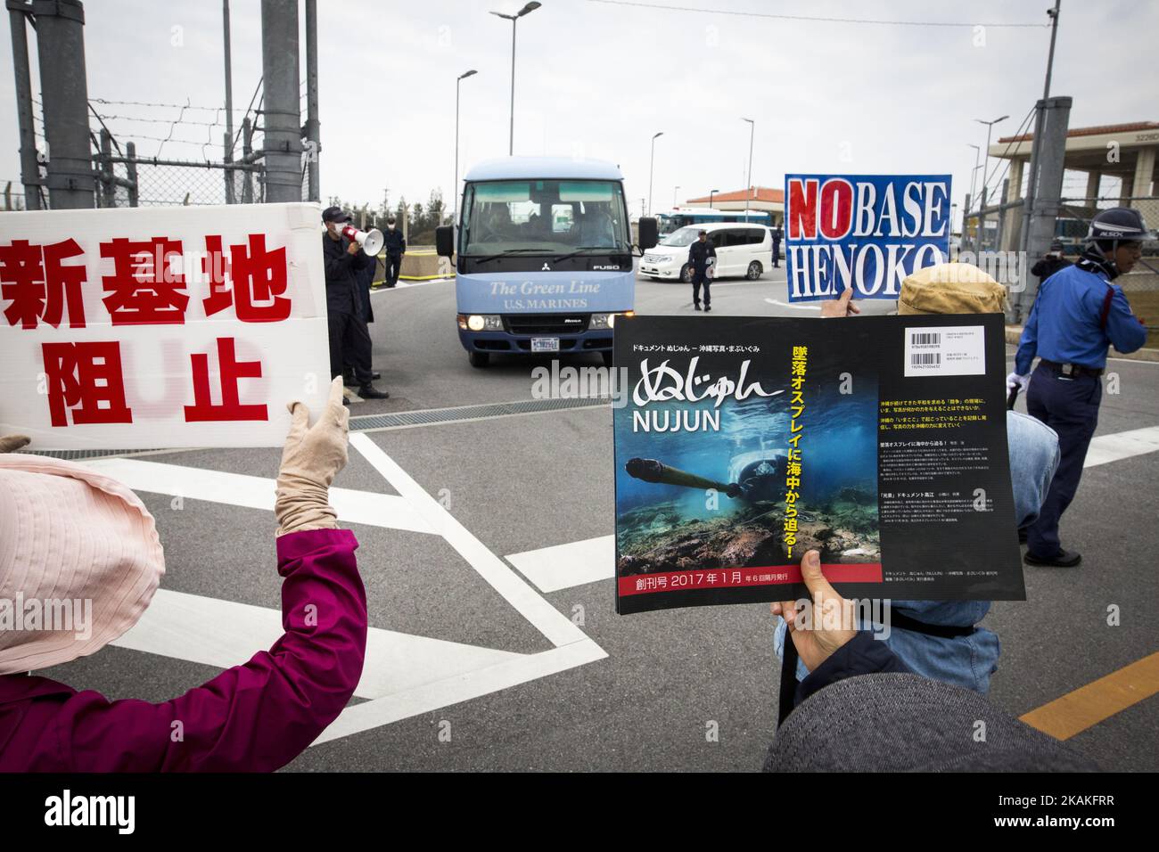 Anti U.S. Base protesters hold placards and block the service of Marines outside of the U.S Marine Camp Schwab gate to protest against the construction of the new U.S Marine Airbase in Nago, Okinawa, Japan on Wednesday, February 1, 2017. Okinawa Gov. Takeshi Onaga arrived in the United States on Tuesday, aiming to convey to President Donald TrumpÂ’s administration local opposition to a plan to relocate a U.S. airbase within the southern island prefecture. (Photo by Richard Atrero de Guzman/NurPhoto) *** Please Use Credit from Credit Field *** Stock Photo