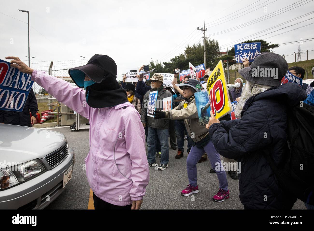 Anti U.S. Base protesters shout with placards and block the cars of US marines from getting out of the U.S Marine Camp Schwab gate, protesting against the construction of the new U.S Marine Airbase in Nago, Okinawa, Japan on Wednesday, February 1, 2017. Okinawa Gov. Takeshi Onaga arrived in the United States on Tuesday, aiming to convey to President Donald TrumpÂ’s administration local opposition to a plan to relocate a U.S. airbase within the southern island prefecture. (Photo by Richard Atrero de Guzman/NurPhoto) *** Please Use Credit from Credit Field *** Stock Photo