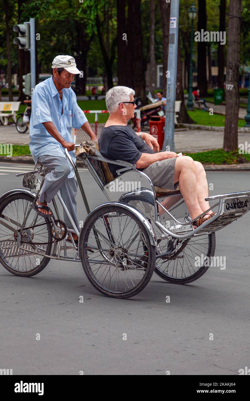 Tourist riding tricycle taxi, Ho Chi Minh City, Vietnam Stock Photo
