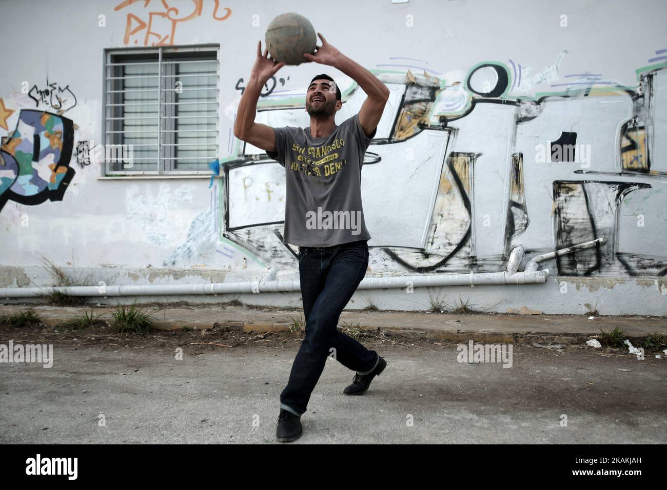 An Afghan man plays with a ball, at the refugee camp of the former international Helliniko airport, south of Athens, Greece, on February 5, 2017. Protesting the living conditions, some refugees started a hunger strike on Sunday morning, demanding better food, hot water and school for their children (Photo by Panayotis Tzamaros/NurPhoto) *** Please Use Credit from Credit Field *** Stock Photo