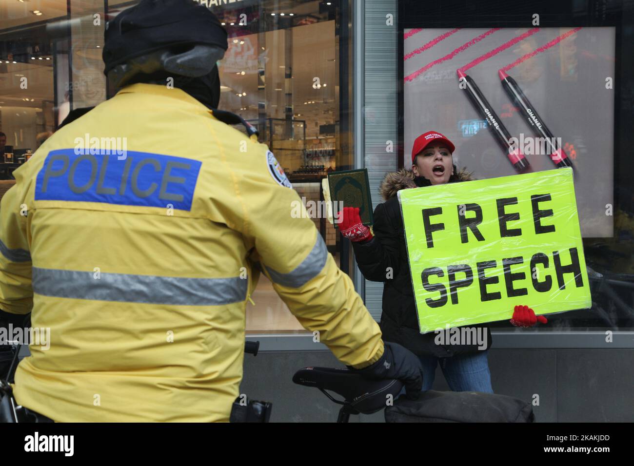 Police cordon off an Iranian woman holding a copy of the Quran and a sign with the words 'Free Speech' as she yells anti-Muslim rhetoric about Muslims planning terror attacks in Canada on February 04, 2017 in downtown Toronto, Ontario, Canada. (Photo by Creative Touch Imaging Ltd./NurPhoto) *** Please Use Credit from Credit Field *** Stock Photo