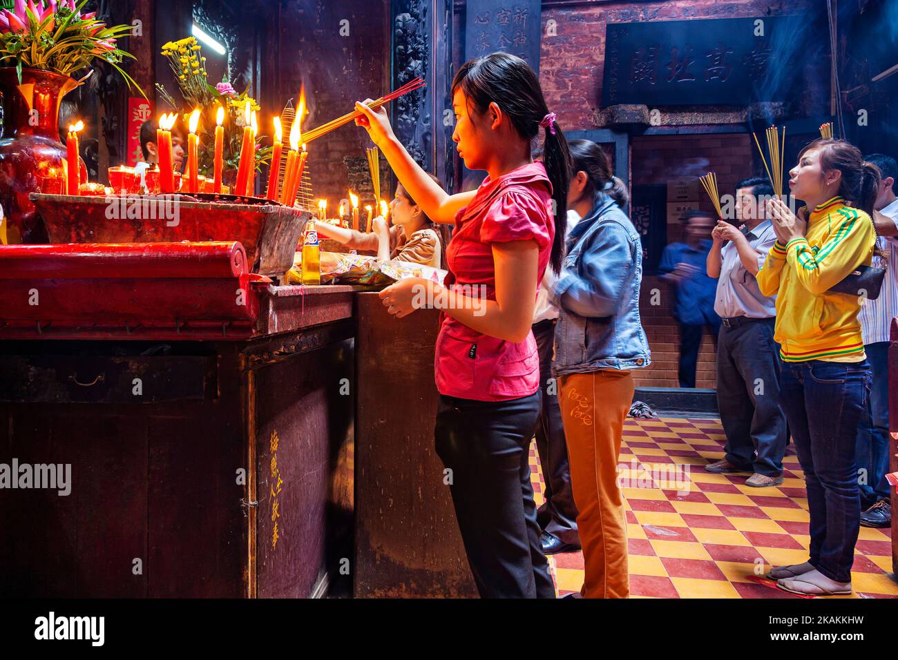 Vietnamese people making offering inside Jade Empress Pagoda, Ho Chi Minh City, Vietnam Stock Photo
