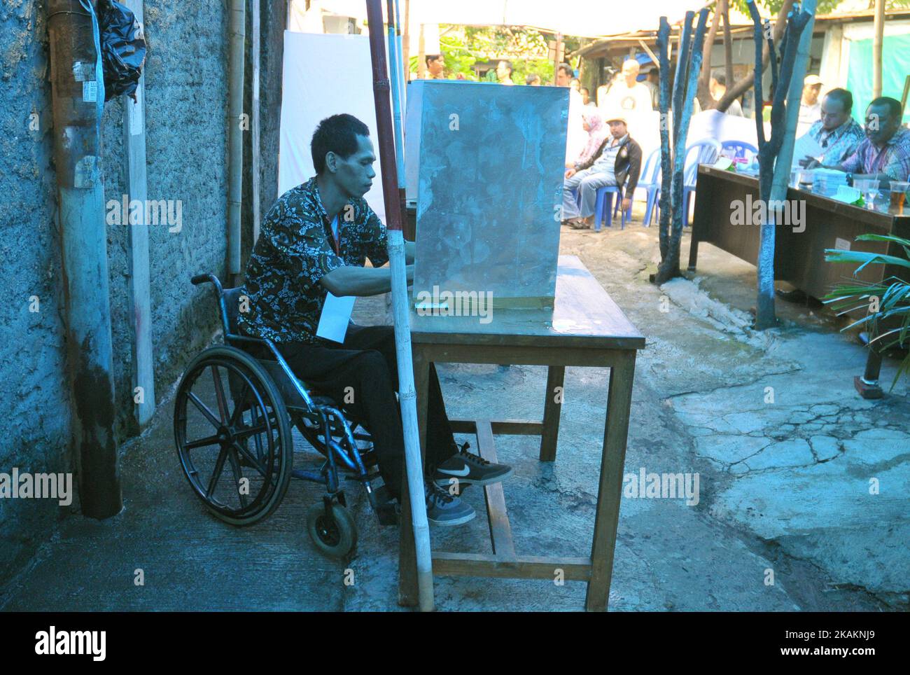 Persons disabilities to the voter booth during the implementation of Jakarta Election ballot in place of voting 43, Pondok Bambu Jakarta on February 15, 2017. The enthusiasm with Disabilities voted (nyoblos). Officers KPPS help guide to determine their voting rights during the implementation of the Jakarta Election ballot this Election Day simultaneously conducted throughout Indonesia to choose the leader of the Regions. Dasril Roszandi (Photo by Dasril Roszandi/NurPhoto) *** Please Use Credit from Credit Field *** Stock Photo