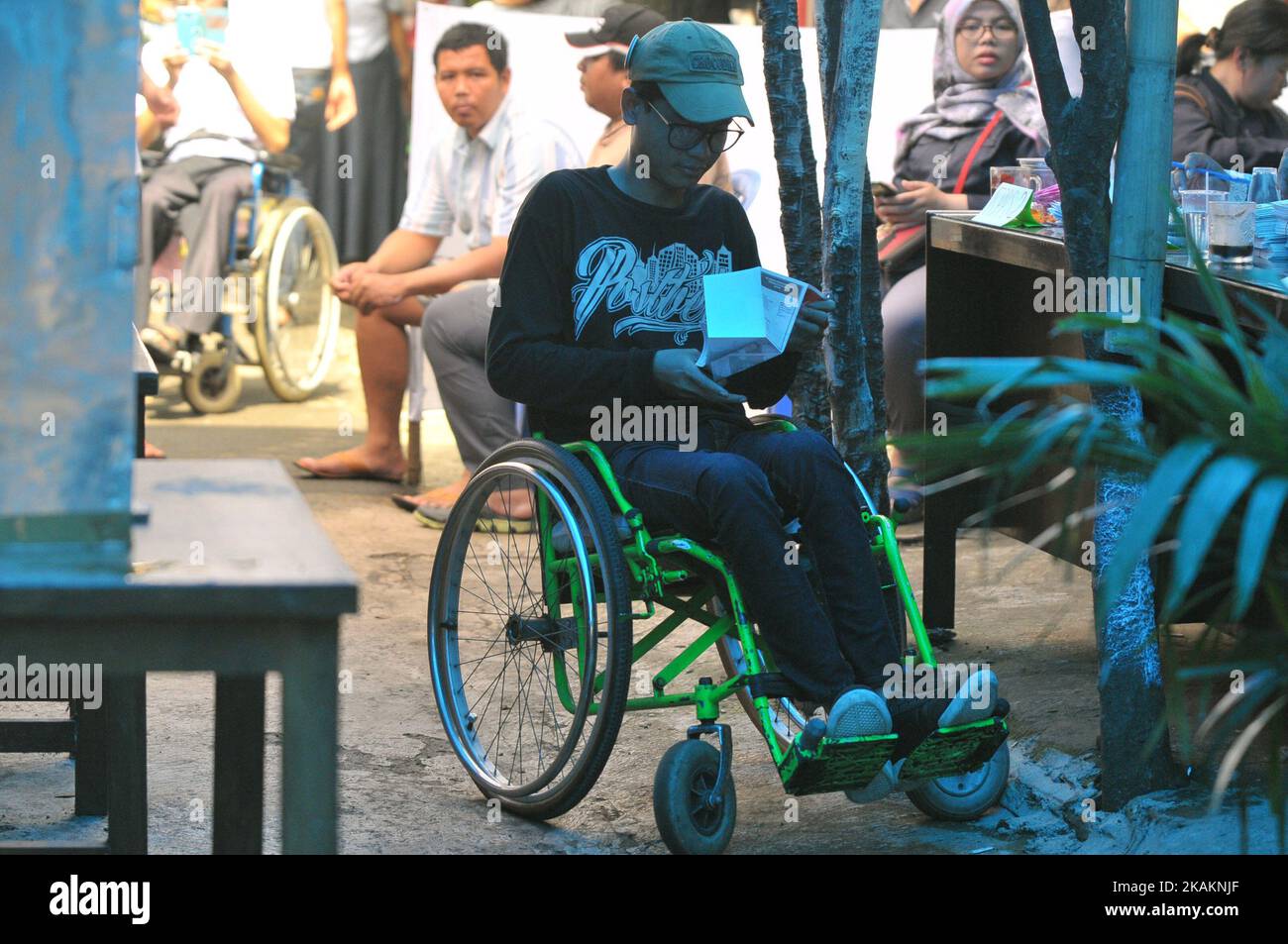 Persons disabilities to the voter booth during the implementation of Jakarta Election ballot in place of voting 43, Pondok Bambu Jakarta on February 15, 2017. The enthusiasm with Disabilities voted (nyoblos). Officers KPPS help guide to determine their voting rights during the implementation of the Jakarta Election ballot this Election Day simultaneously conducted throughout Indonesia to choose the leader of the Regions. Dasril Roszandi (Photo by Dasril Roszandi/NurPhoto) *** Please Use Credit from Credit Field *** Stock Photo