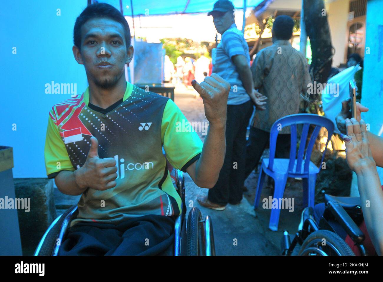 Persons disabilities to the voter booth during the implementation of Jakarta Election ballot in place of voting 43, Pondok Bambu Jakarta on February 15, 2017. The enthusiasm with Disabilities voted (nyoblos). Officers KPPS help guide to determine their voting rights during the implementation of the Jakarta Election ballot this Election Day simultaneously conducted throughout Indonesia to choose the leader of the Regions. Dasril Roszandi (Photo by Dasril Roszandi/NurPhoto) *** Please Use Credit from Credit Field *** Stock Photo