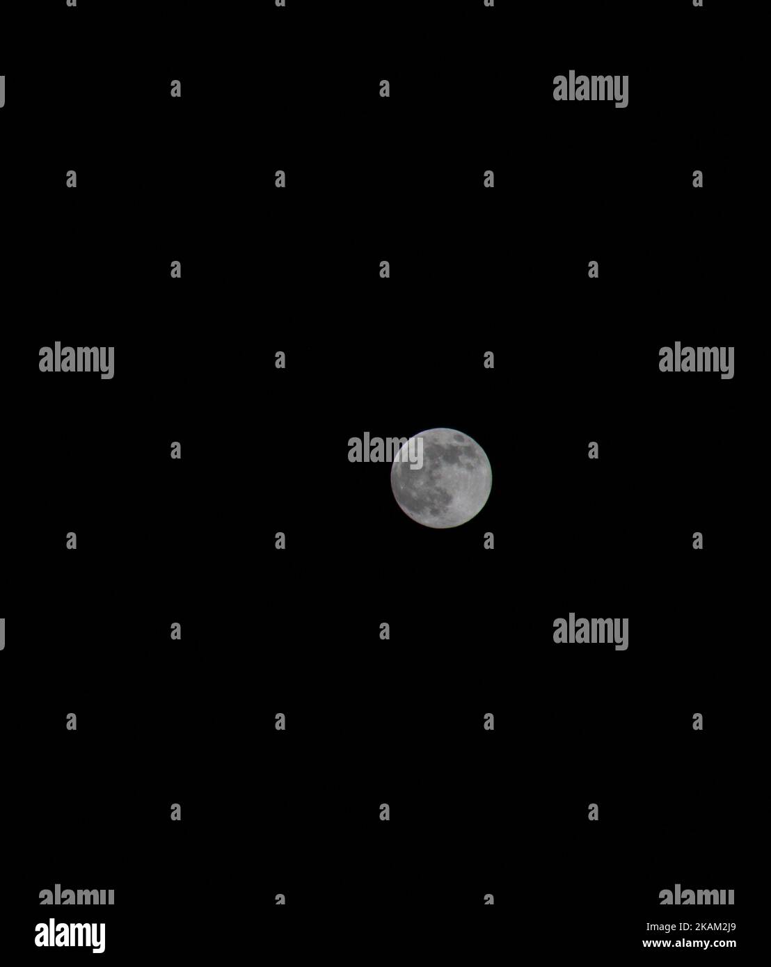 Moon Empty Background A vertical shot of a full moon with its craters isolated on an empty ...
