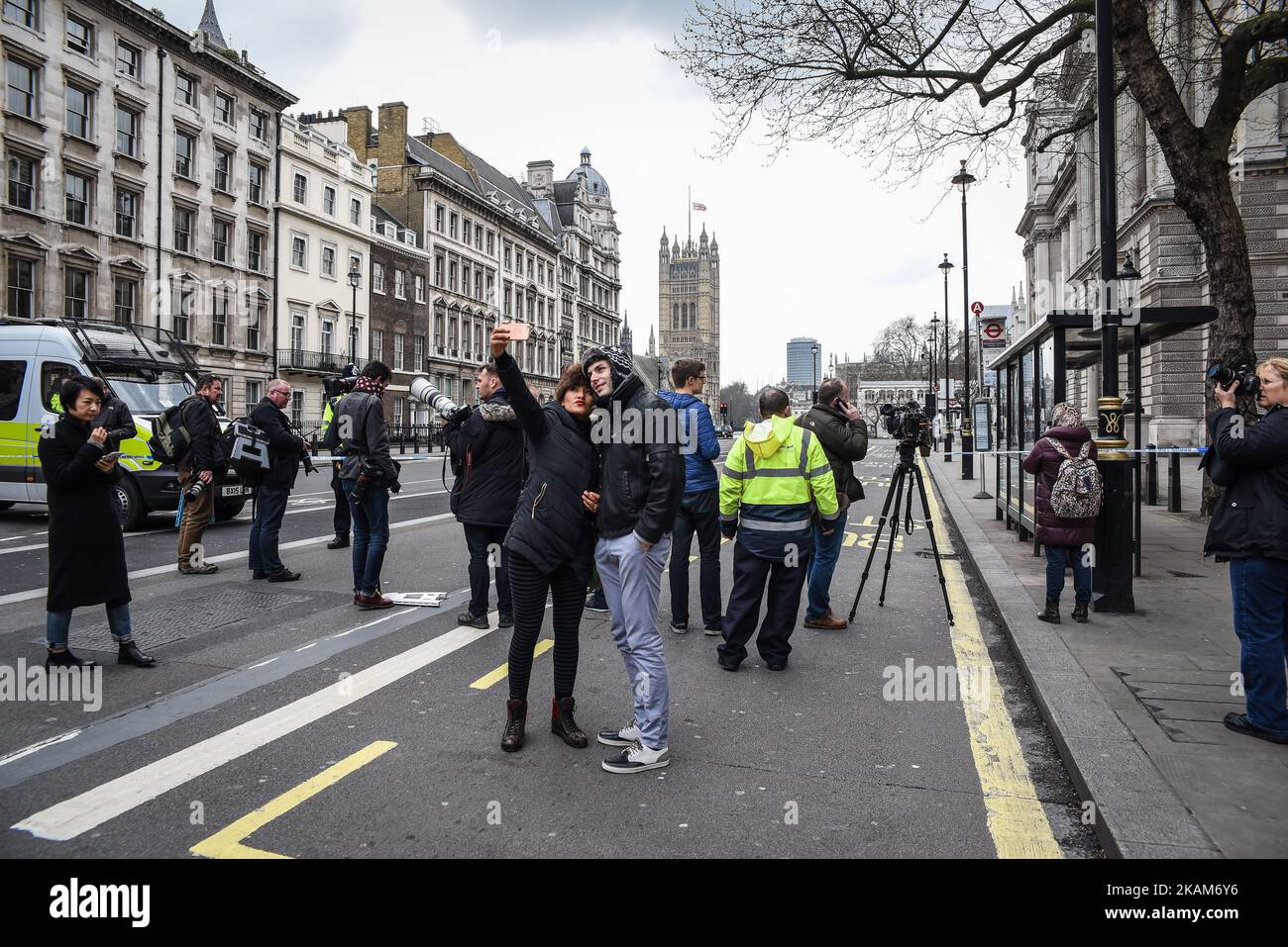 Tourist take a 'selfie' in London, on March 23, 2017. Police continue investigations after the terror attack in London yesterday in which a car was driven into pedestrians on Westminster Bridge and then into railings outside the Houses of Parliament, where a knifeman stabbed a police officer named as PC Keith Palmer, who subsequently died from his injuries. The attacker also died after security forces shot him. Two other people died in the incident and approx 40 were injured, some 'catastrophically'. A woman was pulled alive from the Thames after reportedly jumping off the bridge to escape the Stock Photo