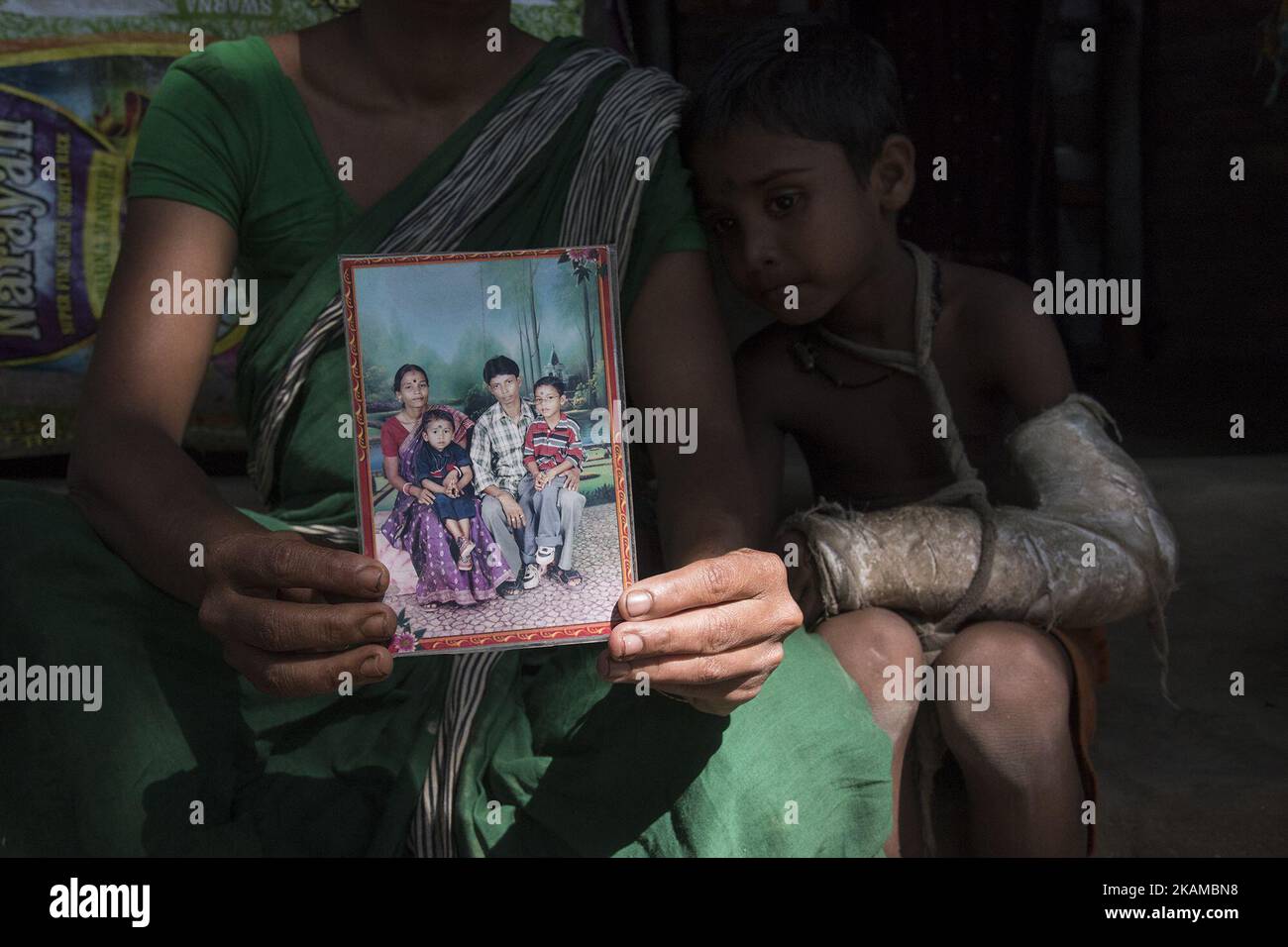 A family lost its bread earner and the child became orphan due to arsenic poisoning. Gaighata, West Bengal, on India 2 April 2017. Gaighata, a village in north 24 parganas located near the Indo Bangladesh border is one of the highly arsenic affected areas of West Bengal. Almost all the water bodies of this area including tube wells produces arsenic contaminated water. Villagers are forced to use arsenic contaminated water for drinking purpose and for every other household chores. According to the WHO, drinking arsenic-rich water over a long period of time results in various health hazards incl Stock Photo