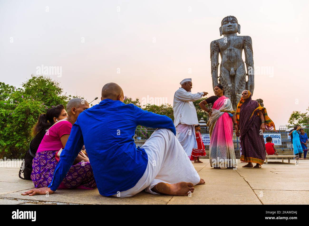 Dharmasthala, Karnataka, India A family of plgrims sits at sunset