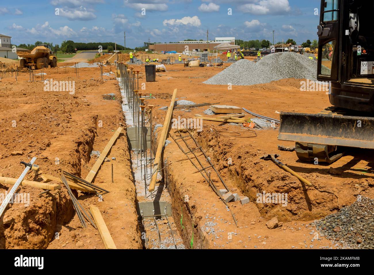 Throughout construction site steel bars rebar wires have been placed into trench to reinforce concrete foundation Stock Photo