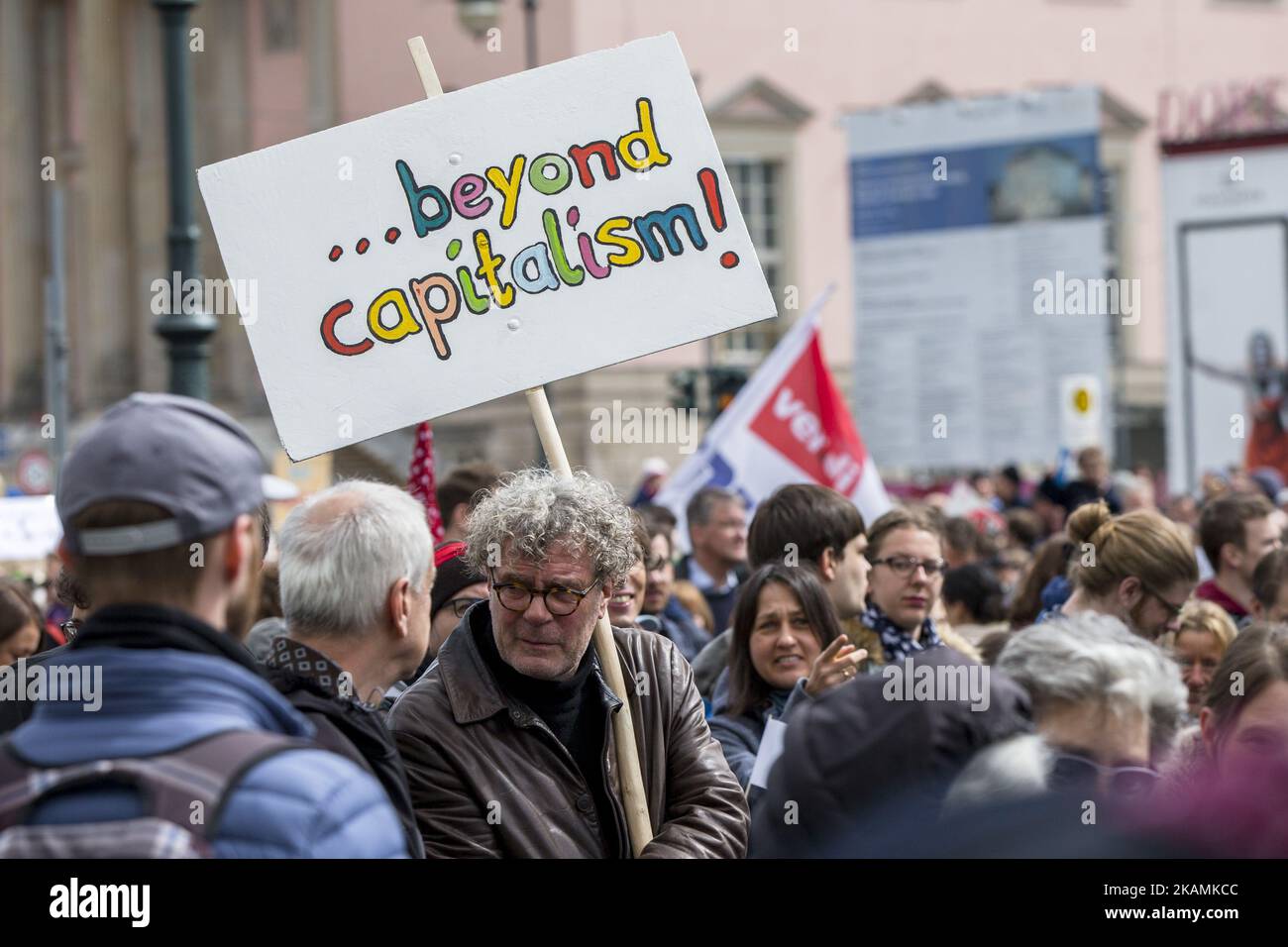 A man attending the 'March for Science' holds a banner reading 'beyond capitalism' in Berlin, Germany on April 22, 2017. Thousands of people rallied and rally today in more than 500 marches all over the world to remark the importance of science and the role of scientifically verifiable facts and results for freedom and democracy against the rise of 'alternative facts'. (Photo by Emmanuele Contini/NurPhoto) *** Please Use Credit from Credit Field *** Stock Photo