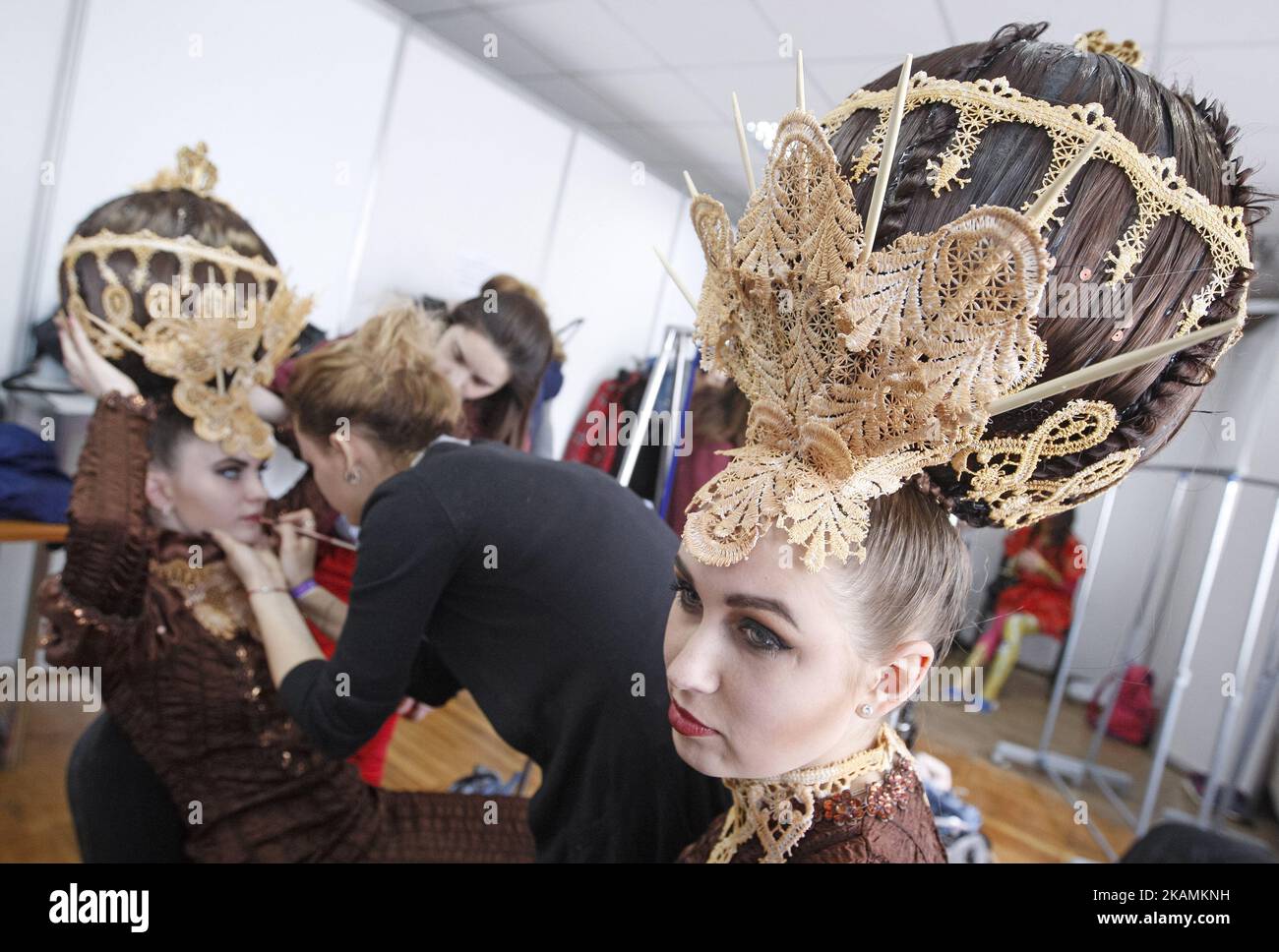 Models get makeup backstage during the annual international