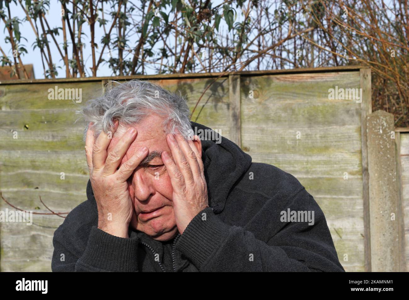 Anxiety. Old or elderly man suffering from stress and anxiety. frightened or terrified. needing help. Stock Photo