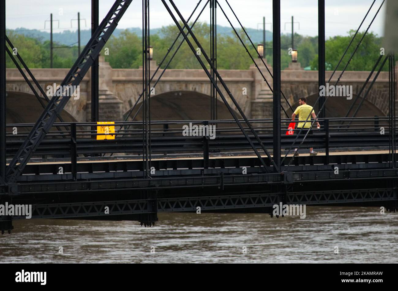 After mounting a one-mile marker a man is seen looking over his shoulder as he continues his way on the Walnut St. Bridge over the Susquehanna River, in Harrisburg, PA, on the morning of April 30, 2017. Diminishing retail, crumbling infrastructure, environmental issues, poverty and unemployment are shown in a view on the current state of a section of rural America on day 101 of Trump's Presidency. The Keystone state Pennsylvania formed an important factor in Trump's victory in the 2016 US elections. (Photo by Bastiaan Slabbers/NurPhoto) *** Please Use Credit from Credit Field *** Stock Photo