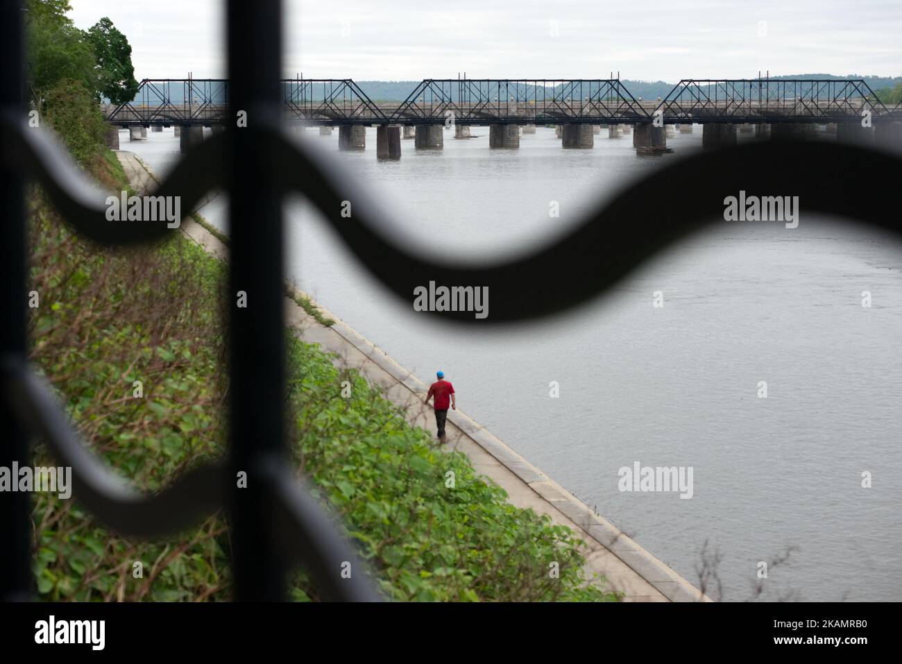 A man walks along the Susquehanna River, in Harrisburg, PA, on the morning of April 30, 2017. Diminishing retail, crumbling infrastructure, environmental issues, poverty and unemployment are shown in a view on the current state of a section of rural America on day 101 of Trump's Presidency. The Keystone state Pennsylvania formed an important factor in Trump's victory in the 2016 US elections. (Photo by Bastiaan Slabbers/NurPhoto) *** Please Use Credit from Credit Field *** Stock Photo