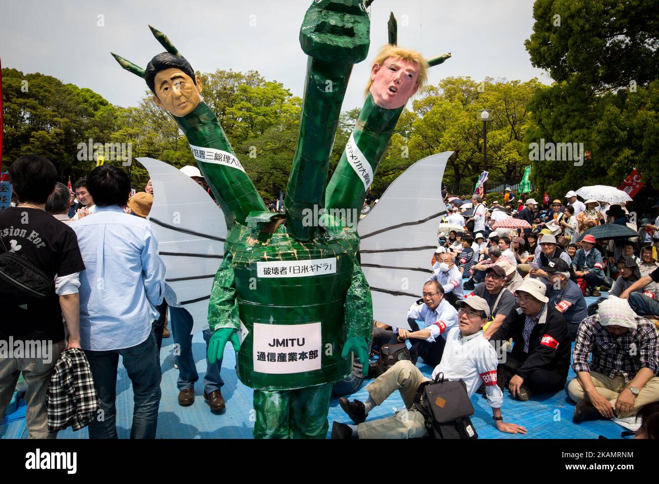 A demonstrator wearing a costume with a dragon head, Shinzo Abe and Donald Trump effigies joins thousands of labor union demonstrators during the May Day Rally at Yoyogi Park on May 1, 2017 in Tokyo, Japan. (Photo by Richard Atrero de Guzman/NurPhoto) *** Please Use Credit from Credit Field *** Stock Photo