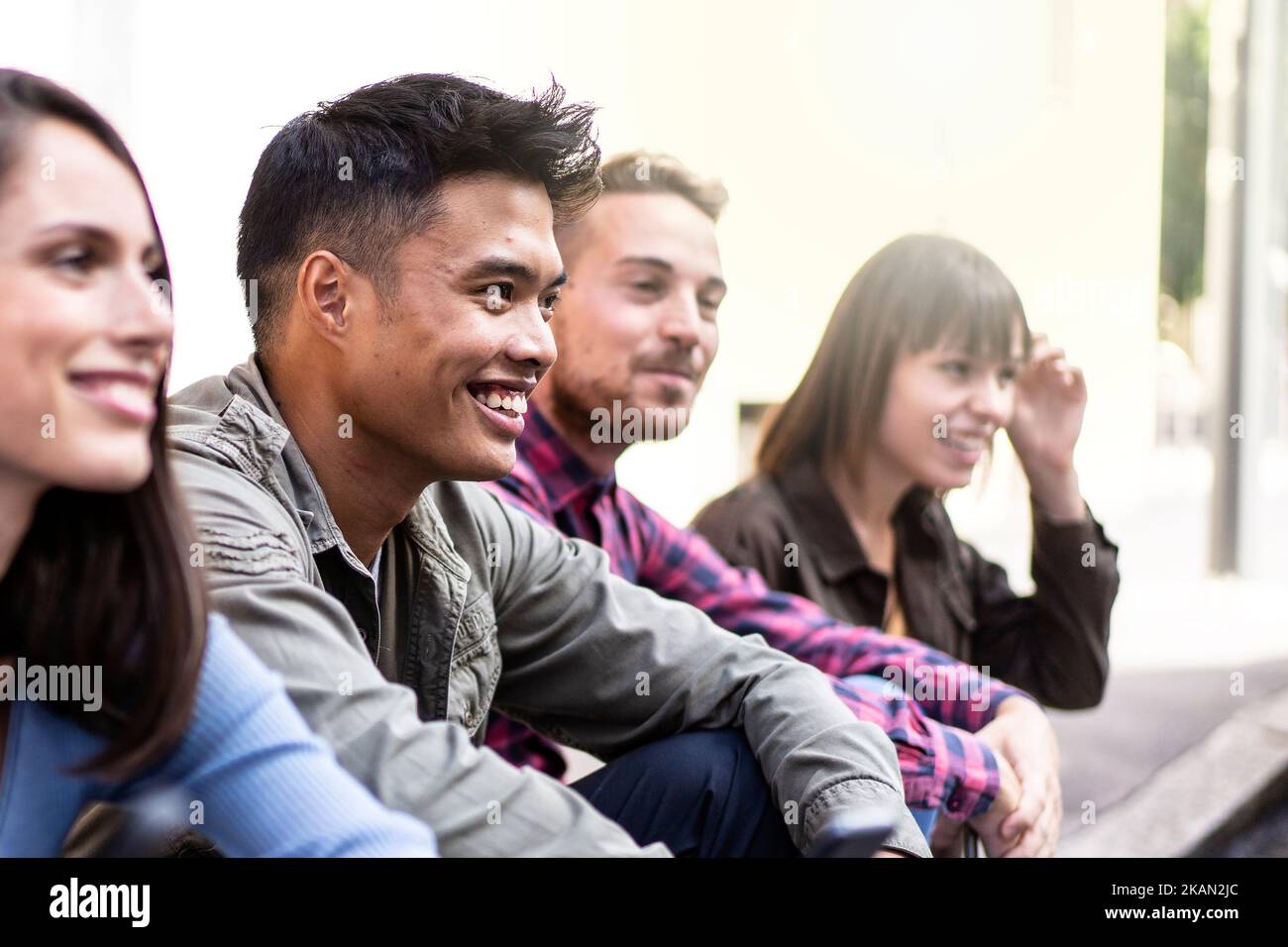 Multicultural people group without smart phone at university college backyard -  Happy millennial friends having fun together sitting at the street - Stock Photo