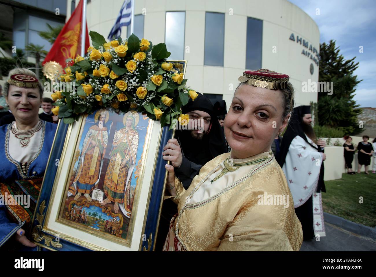 Greek Orthodox women dressed in traditional costumes hold a religious icon with Asent Constantine and St. Helena attend the religious procession during the official reception of the True Cross and Sacred Relics of Aghia Eleni (St. Helena) at Egaleo, west suburb of Athens, Greece, on Sunday May 14, 2017. The relics of Saint Helena were transported from Venice, Italy and will remain in the Pilgrimage Temple of Saint Barbara, in the Municipality of Attica until June 15. (Photo by Panayotis Tzamaros/NurPhoto) *** Please Use Credit from Credit Field *** Stock Photo