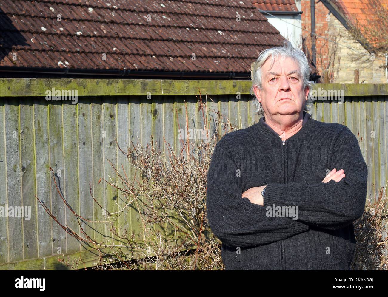 Elderly or senior man looking very smug towards the camera. Defiant and resolute. Stock Photo