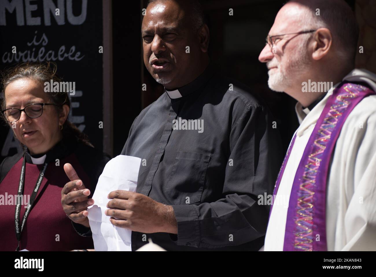 Rev. Canon Marcia Wall (L), Rogers Govender (C), Dean of Manchester, and Rev. Canon David Holgate (R), initiate a set of inter-faith prayers for the victims of the Manchester Arena explosion in Manchester, United Kingdom on Tuesday, May 23rd, 2017. Greater Manchester Police are treating the explosion after the Ariana Grande concert, which took place on 05/22/2017 at Manchester Arena, as a terrorist incident. (Photo by Jonathan Nicholson/NurPhoto) *** Please Use Credit from Credit Field *** Stock Photo