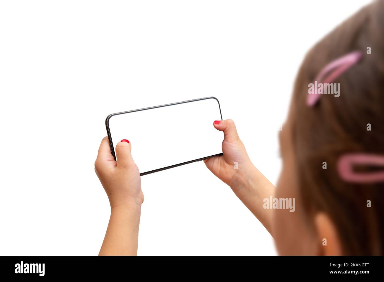 Little girl holding smart phone in horizontal position. Isoalted display and background. Playing game or watch video concept Stock Photo