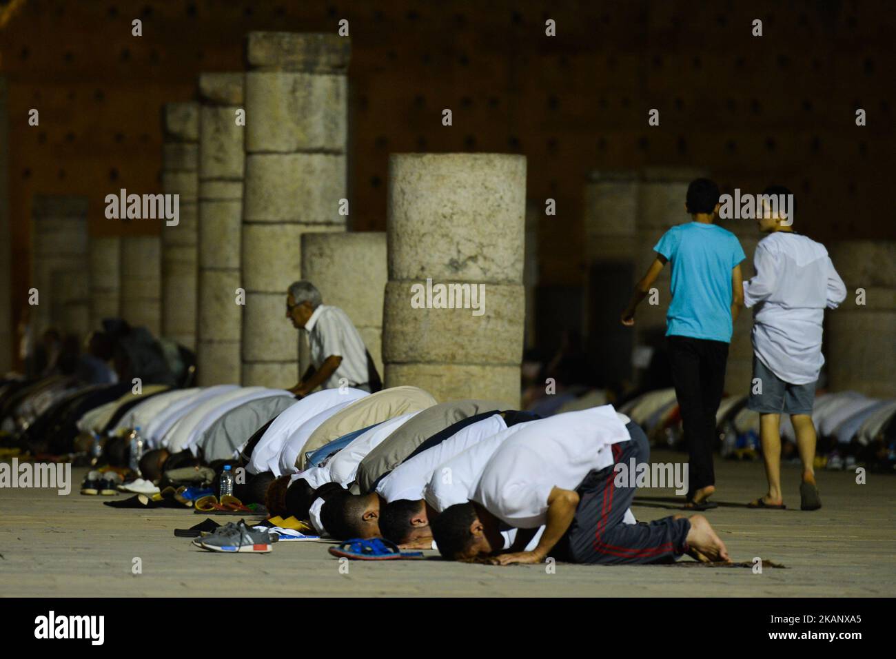 Moroccan worshipers pray during Laylat al-Qadr outside the Mausoleum of Mohammed V in Rabat. Laylat al-Qadr, or Night of Destiny, which falls on the 27th day of Ramadan, in Islamic belief is the night when the first verses of the Quran were revealed to the Islamic prophet Muhammad.. On Thursday, June 22, 2017, in Rabat, Morocco. (Photo by Artur Widak/NurPhoto) *** Please Use Credit from Credit Field ***  Stock Photo