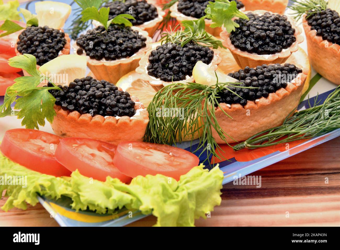 Tartlets with caviar and fresh herbs for the New Year's table Stock Photo