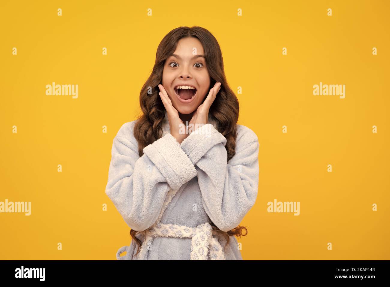 Shocked teenager child with amazed look on yellow background, amazement ...