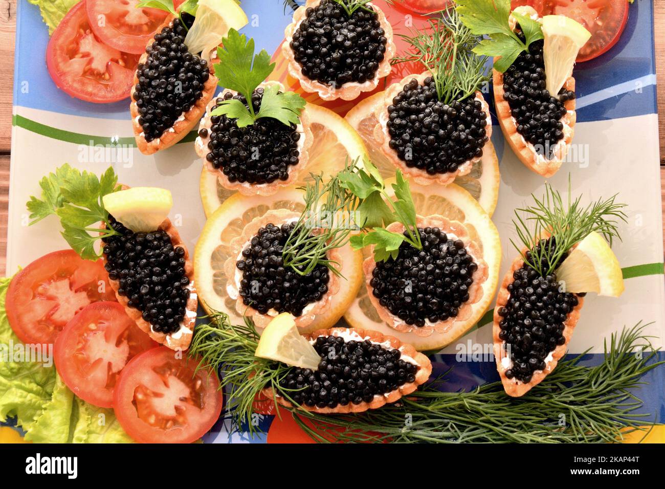 Tartlets with caviar and fresh herbs for the New Year's table Stock Photo