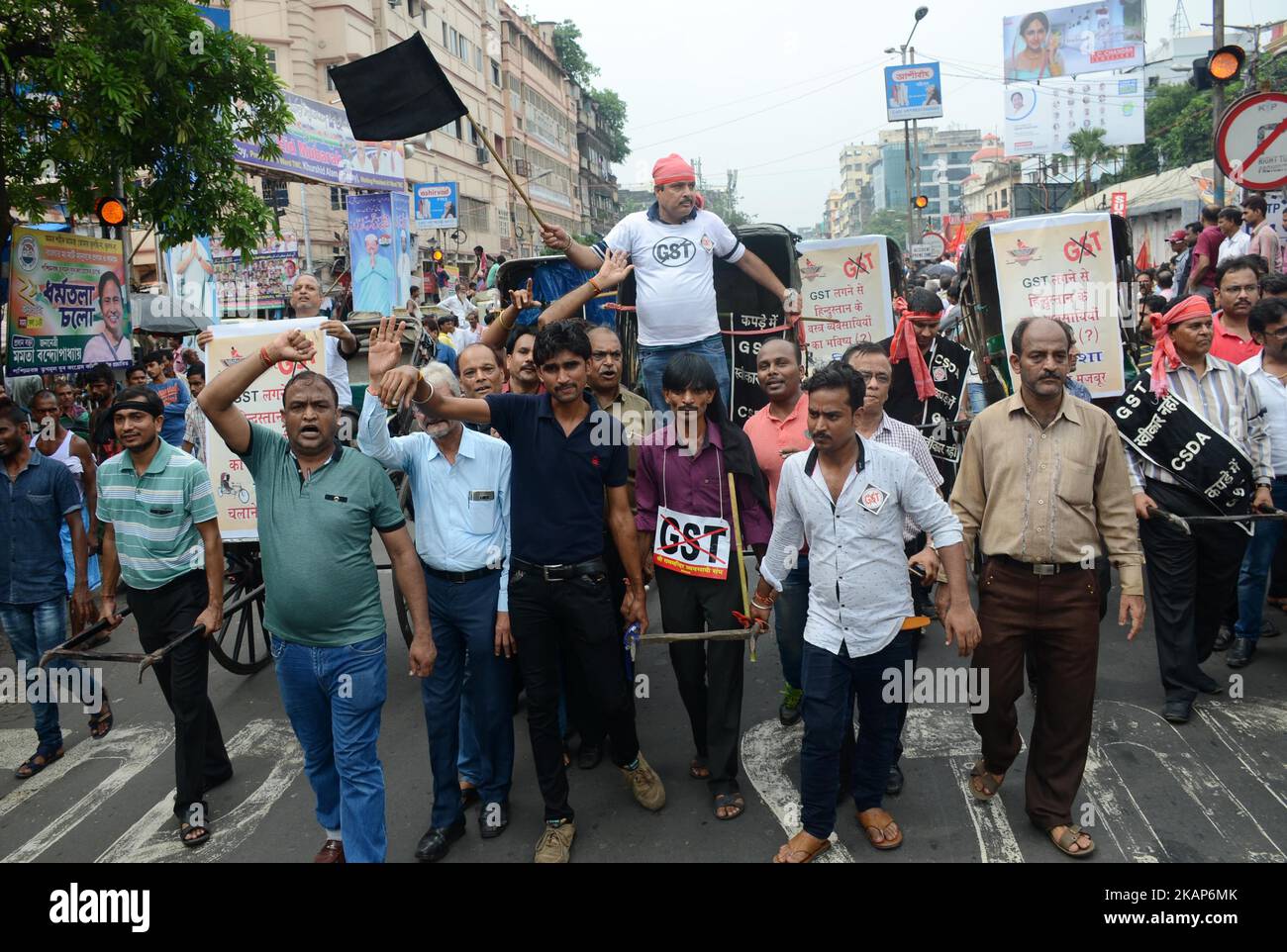 Cloth merchants and workers shout slogans and pulling the Rickshaw at Burrabazar during the strike against GST in Kolkata , India on Wednesday, 12th July , 2017.Cloth merchants go on nationwide strike beginning June 27 in protest of 5 per cent GST (Goods and Services Tax) levied on the services (job work) rendered by them for the textile industry. Textile traders protest against ‘complex, confusing’ GST (Goods and Service Tax) rules in all over the country. (Photo by Sonali Pal Chaudhury/NurPhoto) *** Please Use Credit from Credit Field *** Stock Photo