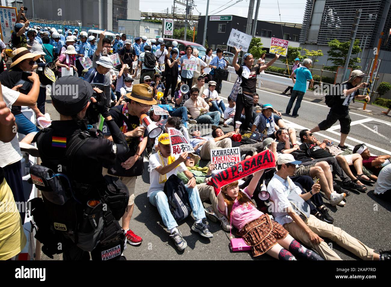 Anti-racist groups tried to block Japanese nationalists from marching on the street during a counter-protest rally demanding an end to hate speech in Kawasaki City, Kanagawa prefecture, Japan on July 16, 2017. Scuffles erupted during a counter-protest on racism in Kawasaki City's Nakahara on Sunday, during a right-wing activists attempt to march with their slogans, flags, racist speech, forcing police to intervene. (Photo by Richard Atrero de Guzman/NUR Photo) *** Please Use Credit from Credit Field *** Stock Photo