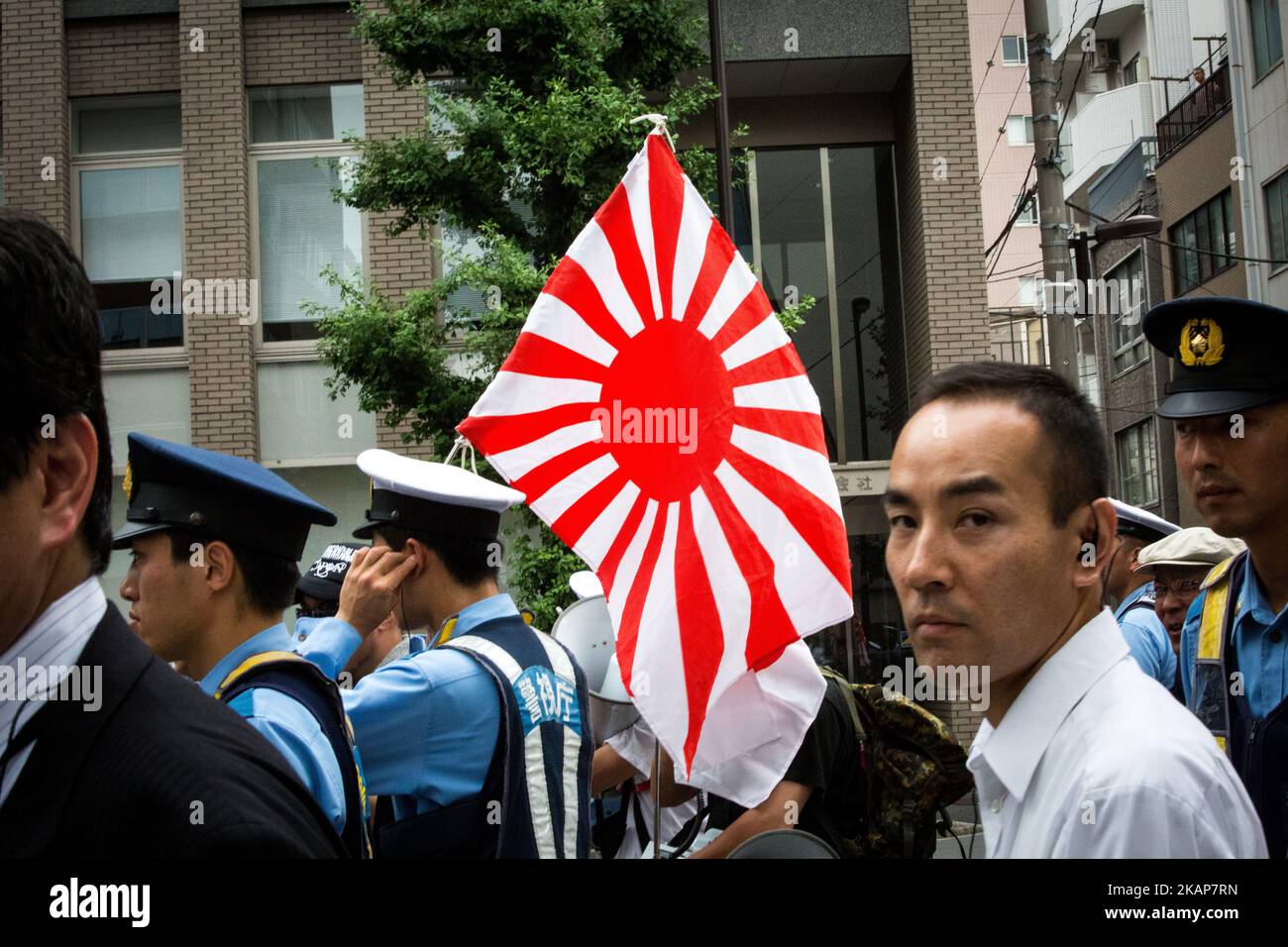 Japanese nationalists holding Japanese maritime flags, escorted by police, took to the streets in a 'hate demonstration' in Akihabara, Tokyo, Japan on July 16, 2017. The nationalists faced off with anti-racist groups who mounted counter protests demanding an end to hate speech and racism in Japan. (Photo by Richard Atrero de Guzman/NUR Photo) *** Please Use Credit from Credit Field *** Stock Photo