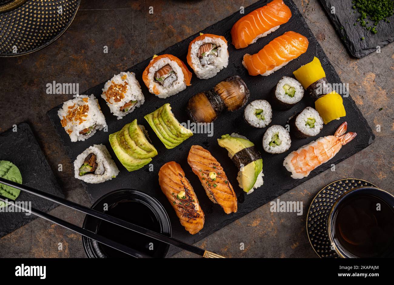 https://c8.alamy.com/comp/2KAPAJM/top-view-of-assorted-sushi-big-sushi-set-on-slate-2KAPAJM.jpg
