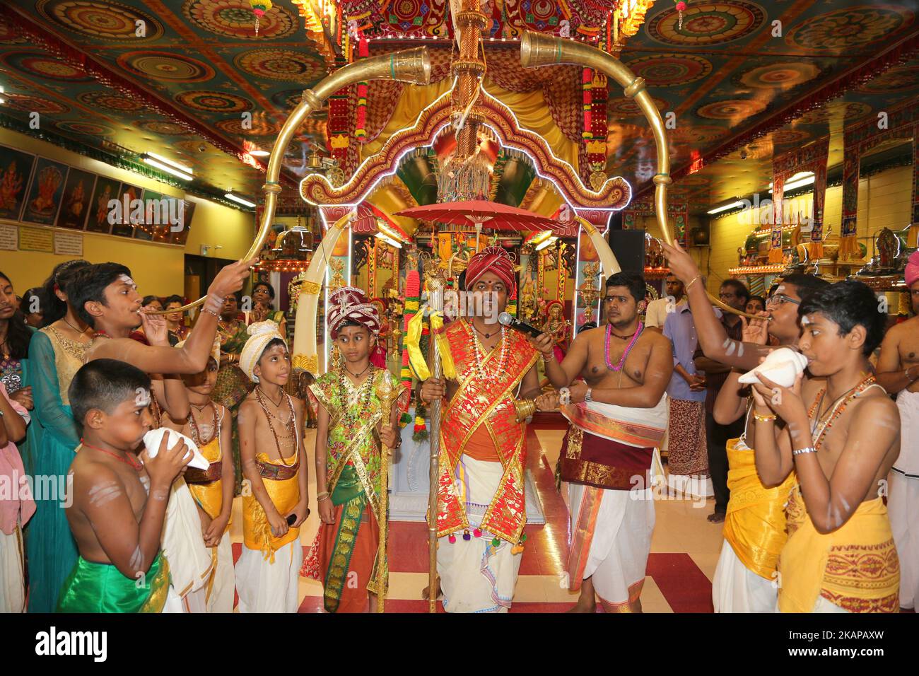 Tamil Hindu priest recites prayers as horns are sounded signifying the ...