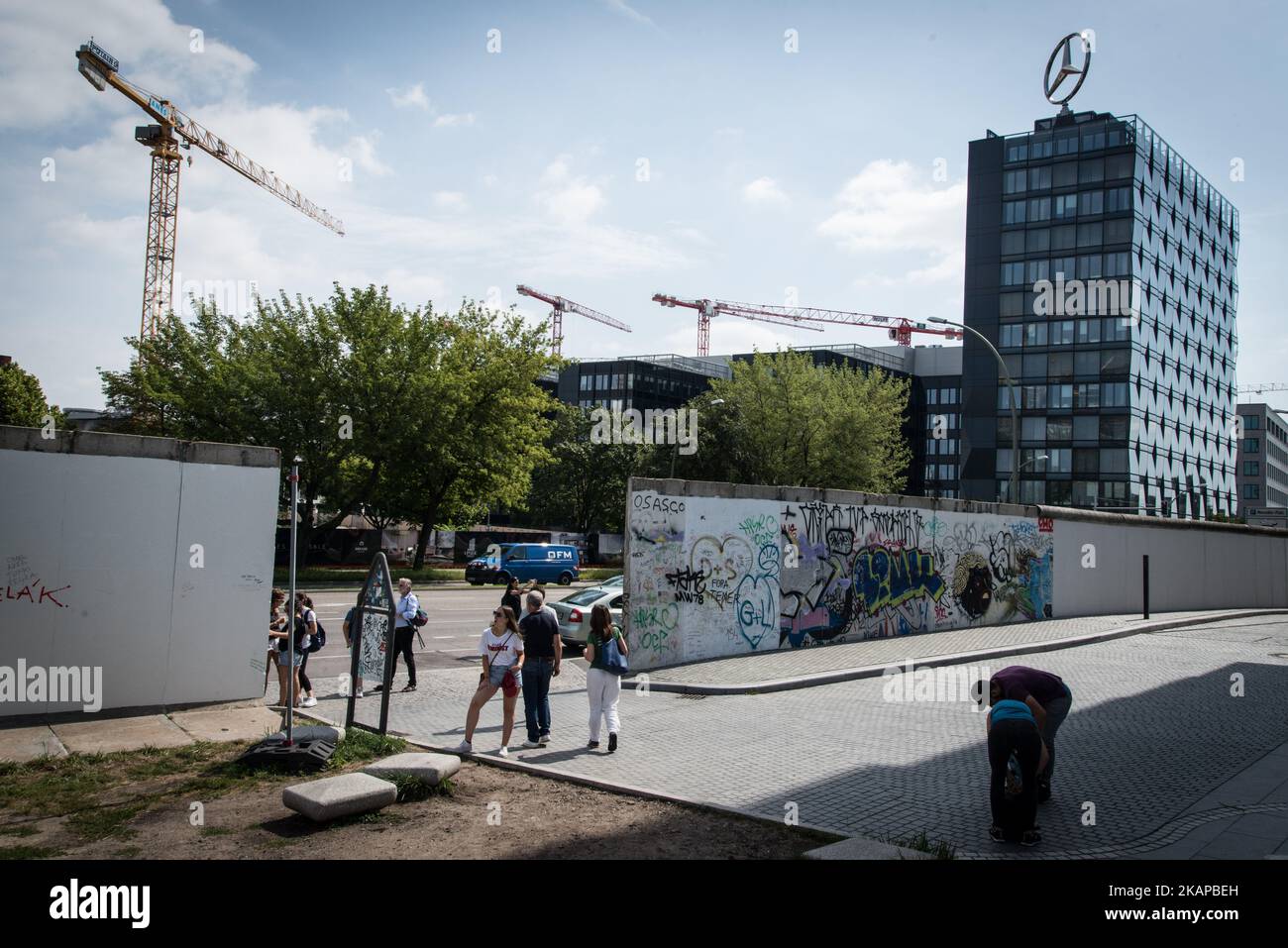 Visitors walk along the East Side Gallery, a milelong section of the
