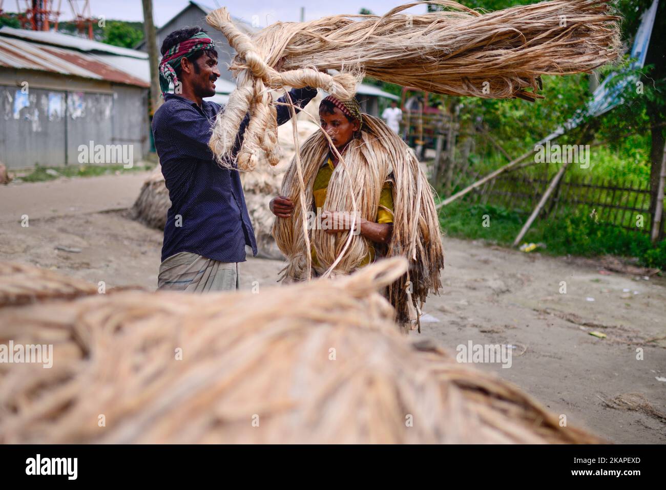 A Bangladeshi worker carries jute for trade at a local market in Ashulia, outside of Dhaka, Bangladesh, August 3, 2017. Bangladesh produces the finest quality natural jute fiber. As such Bangladeshi jute product manufacturer or exporter has an extra advantage in manufacturing top grade jute products by using best quality natural fiber. (Photo by Mehedi Hasan/NurPhoto) *** Please Use Credit from Credit Field *** Stock Photo