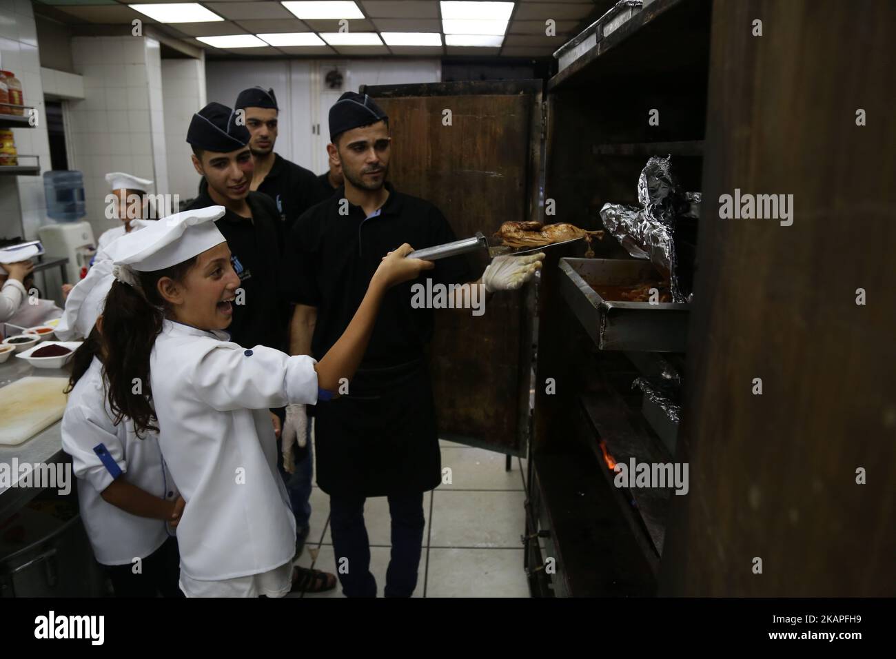 Palestinian children join in a training program on how to become a chef ...