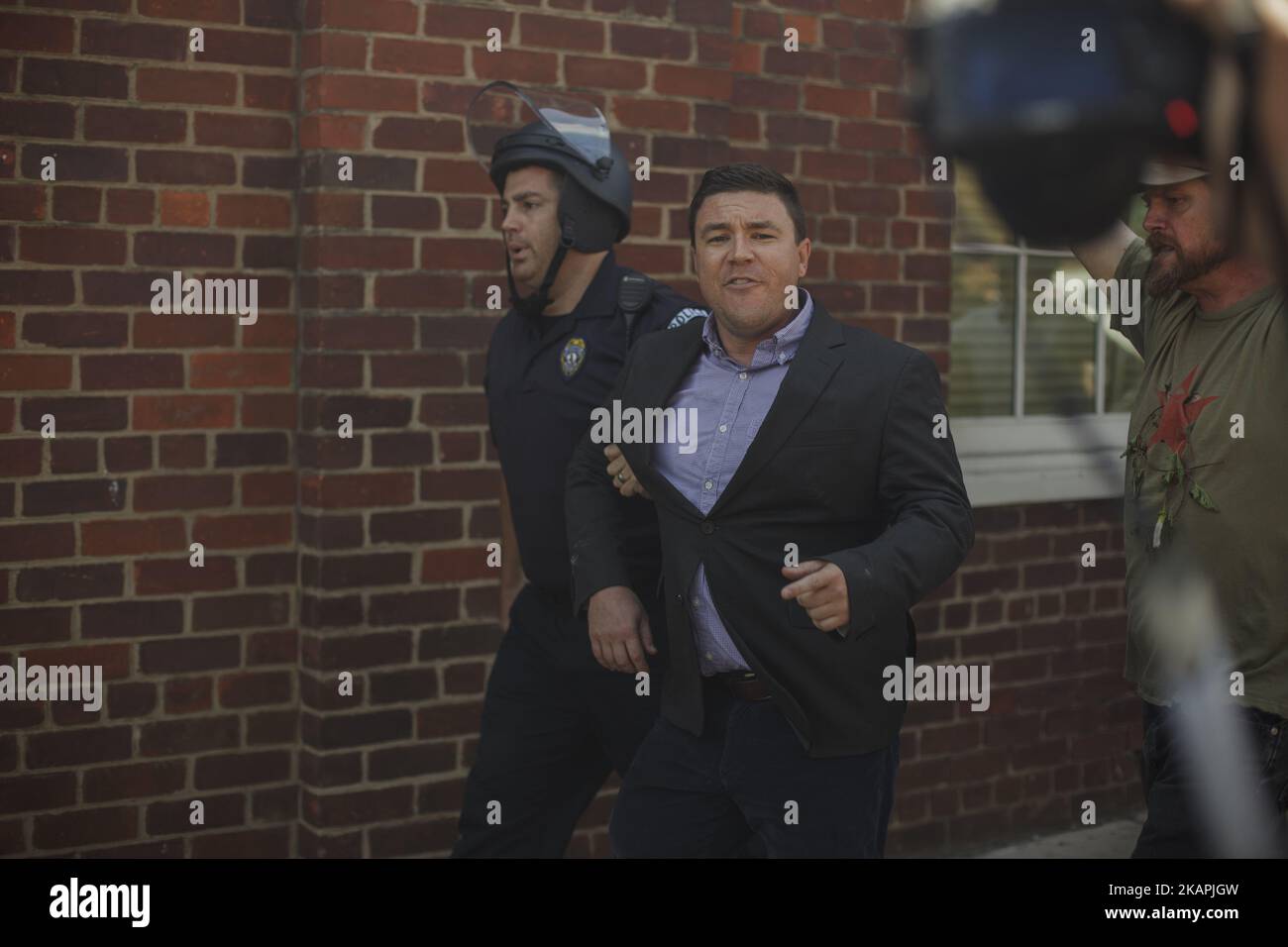 Jason Kessler being escorted away by State Police in Charlottesville, VA on August 13,2017. Jason Kessler, one of the main organizers for the Unite The Right Rally held this weekend in Charlottesville, attempted to hold a press conference to counter the events of Saturday. The conference last about 3 minutes before Kessler was evacuated by Virginia State Police. (Photo by Shay Horse/NurPhoto) *** Please Use Credit from Credit Field *** Stock Photo