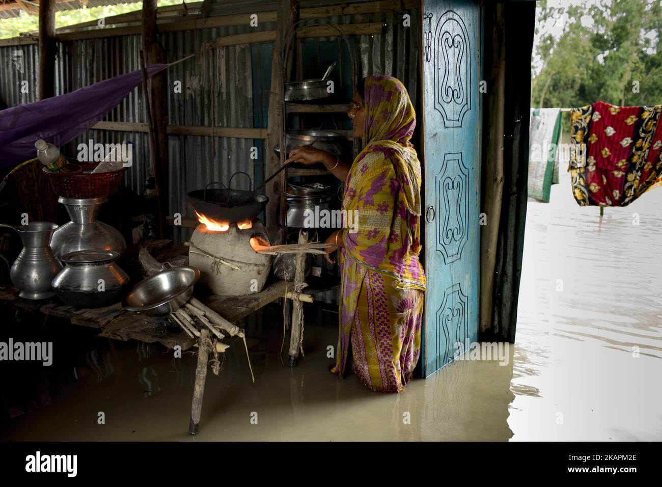 A woman in Sariakandhi area at Bogra, Bangladesh on August 16, 2017. Peoples’ suffering continues as many of them left their homes along with their cattle, goats, hens and other pets and took shelter in safe areas and many of these people have still not been able to return as water has not fully receded from their homes. Flood-related incidents in Dinajpur, Gaibandha and Lalmonirhat raising the death toll to 30 in the last three days across the country. (Photo by KM Asad/NurPhoto) Stock Photo
