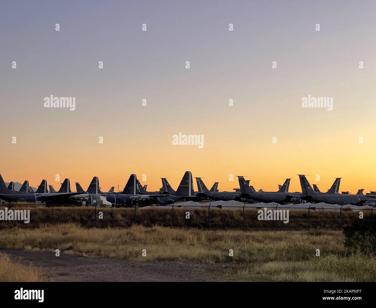 The vast desert floor is covered by thousands of mothballed military aircraft, planes, helicopters, and parts. Stock Photo