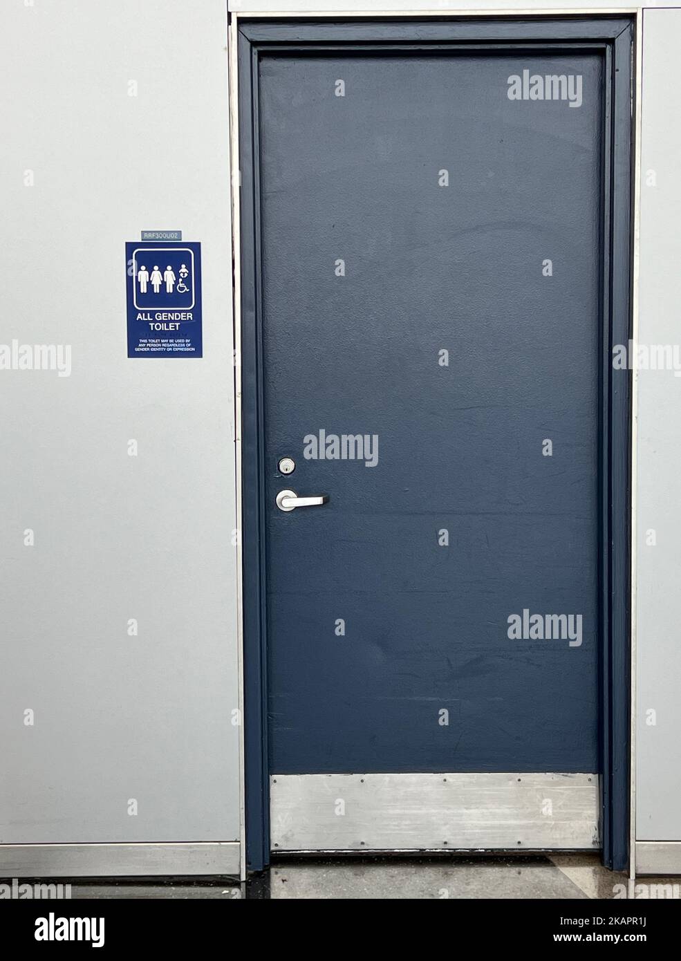 The vertical view of Gender neutral public restroom's gray door Stock Photo - Alamy