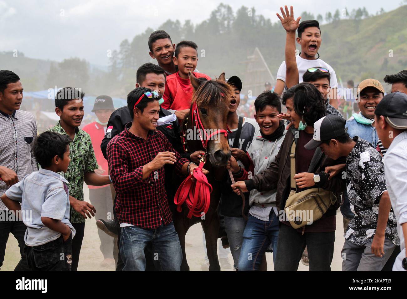 Acehnese child jockey compete during traditional horse race in Takengon on August 27, 2017 in Aceh Province, Indonesia.The Jockey child goes without shirt and does not use protective equipment while in the field where the runway area has no barrier and security. Gayo traditional horse racing has been going on since the Dutch colonial period and became Gayo society tradition, held annually by the government. (Photo by Fachrul Reza/NurPhoto) Stock Photo