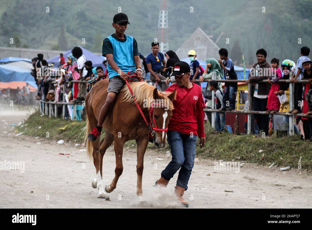 Acehnese child jockey compete during traditional horse race in Takengon on August 27, 2017 in Aceh Province, Indonesia.The Jockey child goes without shirt and does not use protective equipment while in the field where the runway area has no barrier and security. Gayo traditional horse racing has been going on since the Dutch colonial period and became Gayo society tradition, held annually by the government. (Photo by Fachrul Reza/NurPhoto) Stock Photo