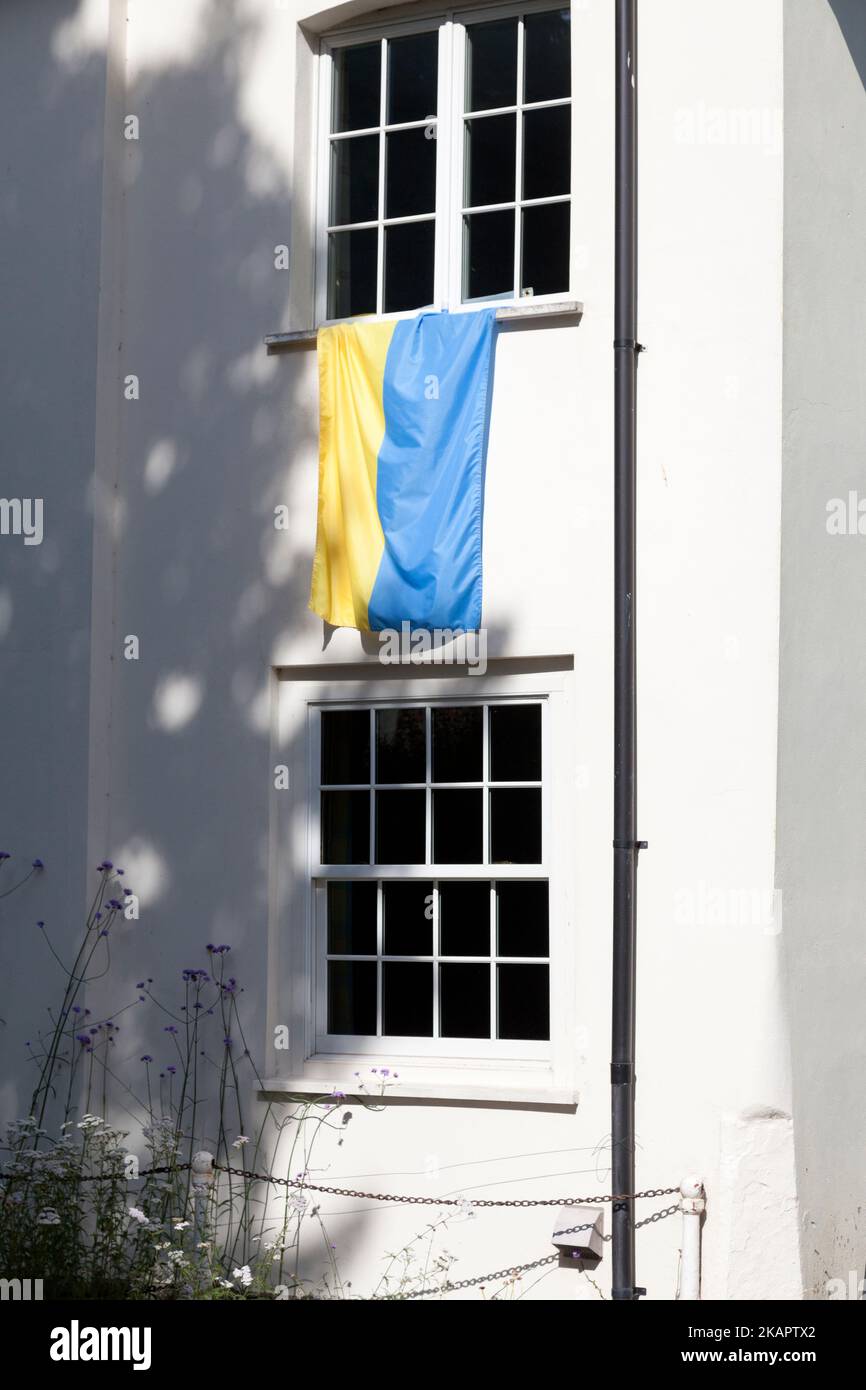 Flag of Ukraine hanging from house window, Almeley, Herefordshire Stock Photo