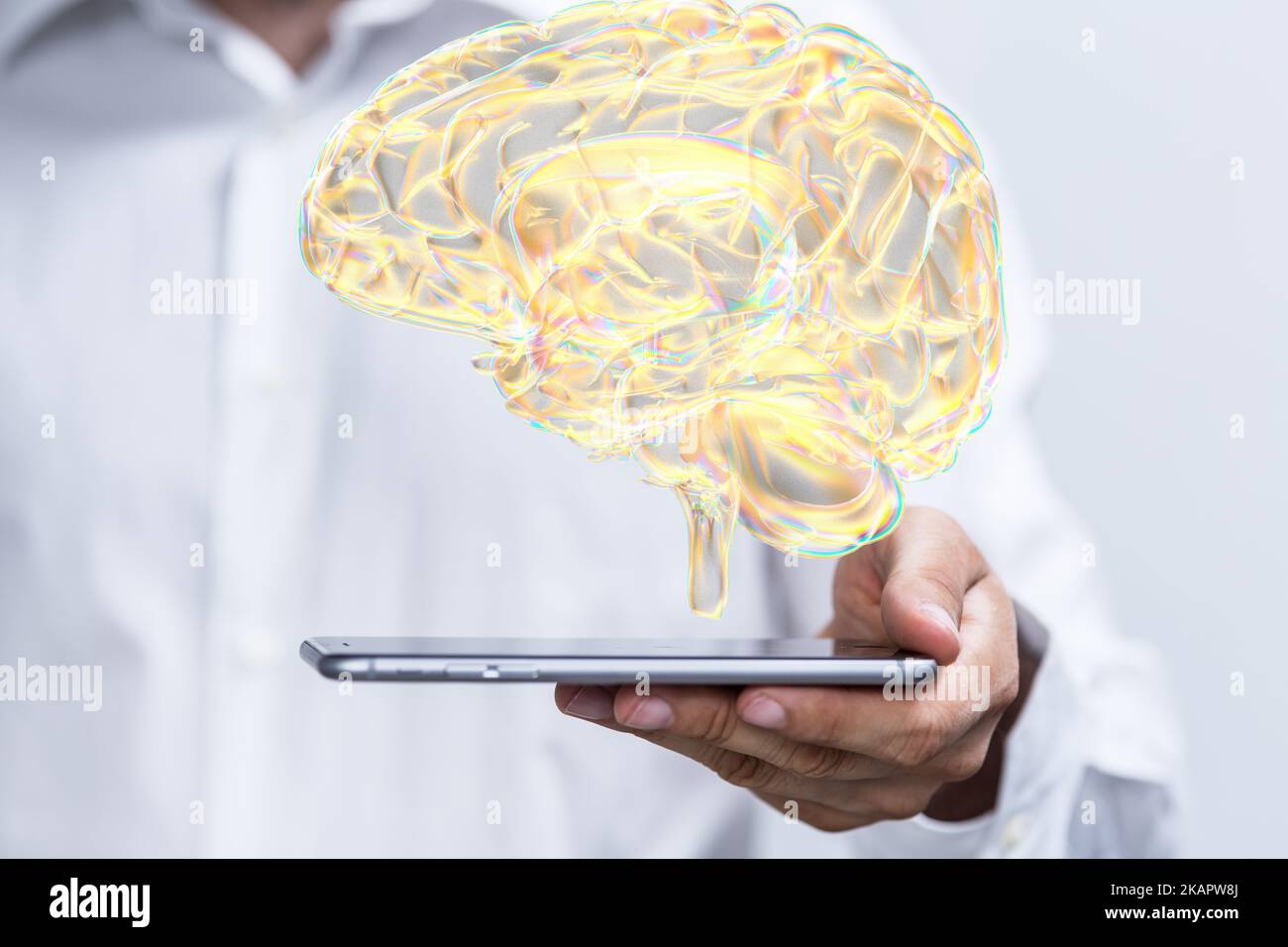 A digital brain icon floating above a tablet - a creativity and high IQ concept Stock Photo