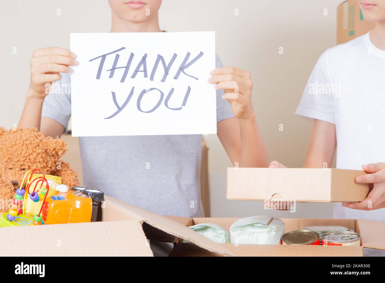 Thank you for donation. Volunteers collecting donations for charity. Teenagers holding paper